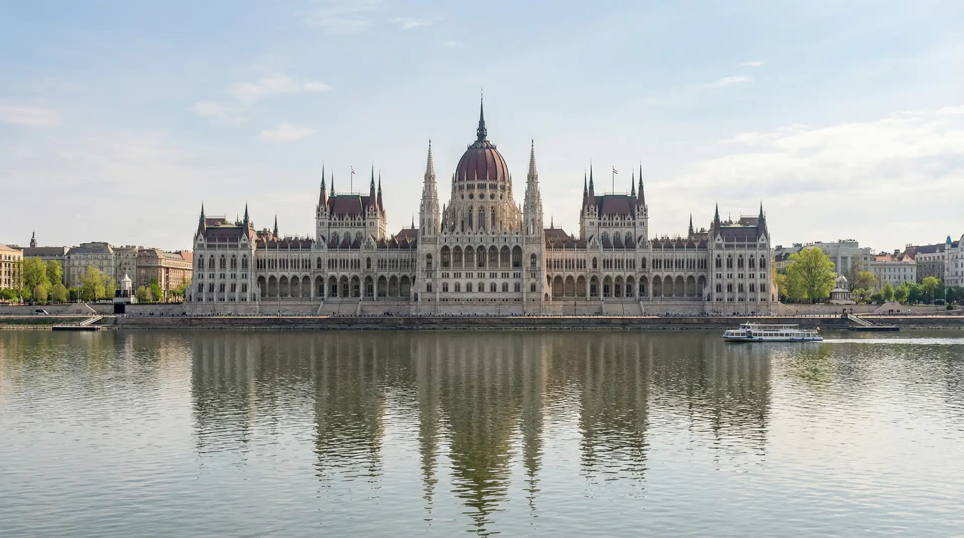 Hungarian Parliament Building along the Danube River at sunset in Budapest Hungary — OraVisa Hungary visa services from Dubai