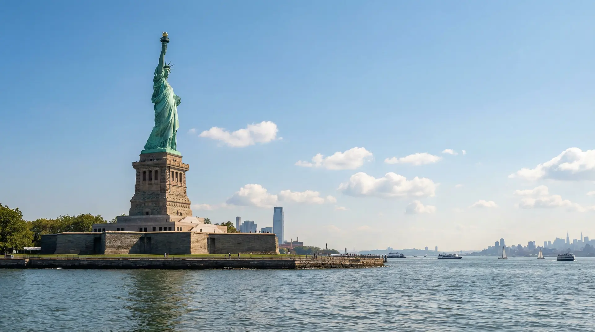 Statue of Liberty with New York City skyline and blue sky — OraVisa USA visa services from Dubai